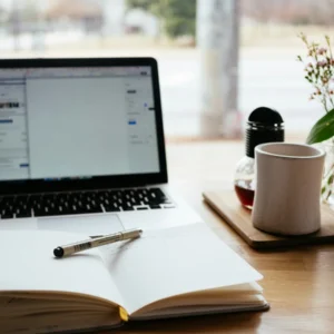 Laptop, notebook and coffee on a desk